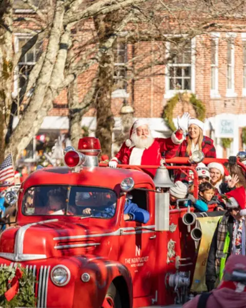 Santa waving from an antique fire truck in the Stroll parade