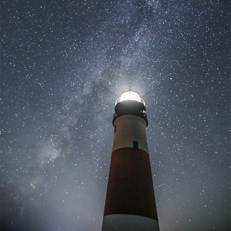 looking up at Sankaty Lighthouse with a starry night sky